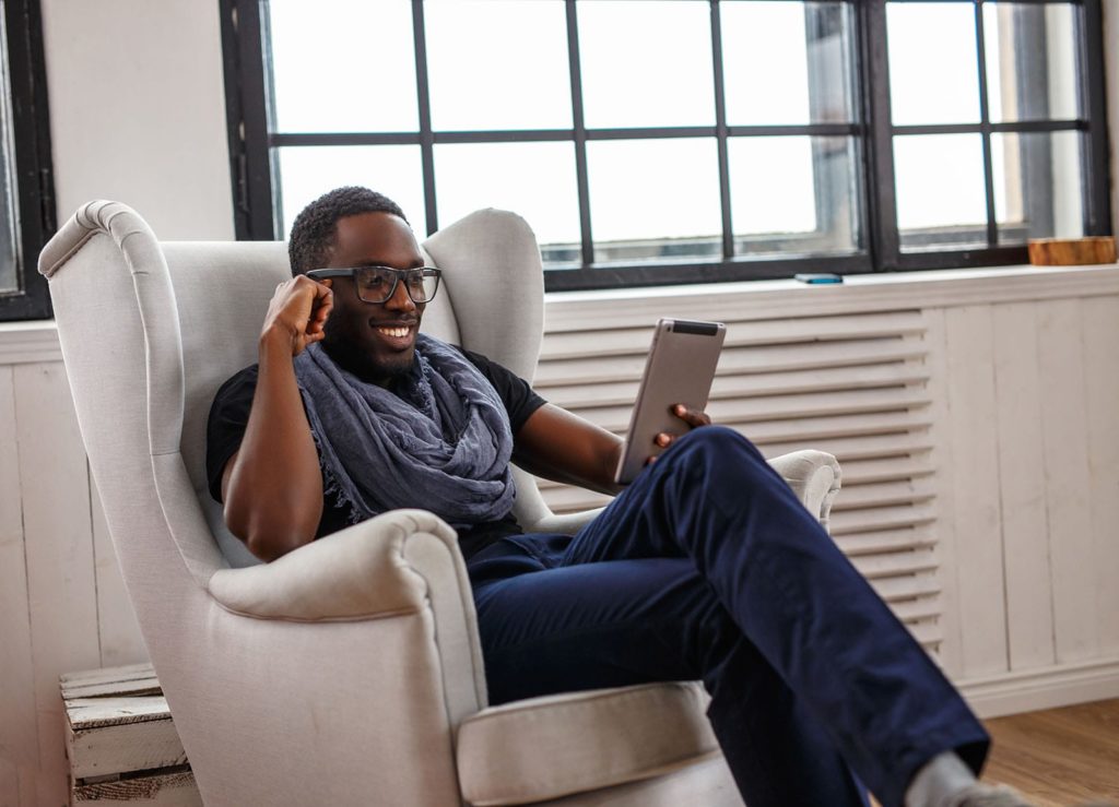 a-man-in-eyeglasses-using-tablet-computer-min